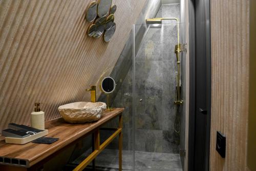 a bathroom with a shower and a counter with a sink at Sunken Tsaghkadzor in Tsaghkadzor