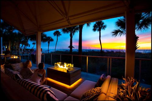 a couple sitting on a porch watching the sunset at The Don CeSar in St Pete Beach