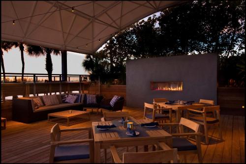 a patio with tables and chairs and a fireplace at The Don CeSar in St Pete Beach