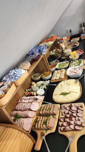 a table topped with lots of different types of food at Hotel Nenufar Premium in Kościan