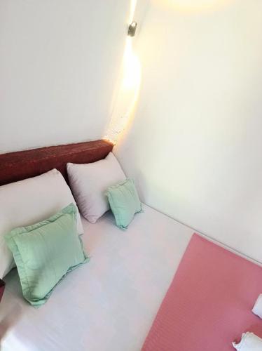 two pillows sitting on a bed in a room at FR Resort in Pottuvil