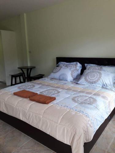 a large bed with two towels on top of it at Pingpong 's house Koh chang in Ko Chang