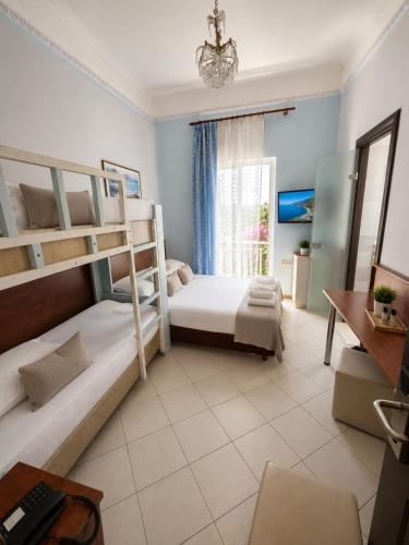 a bedroom with two bunk beds and a desk at Diethnes Hotel in Athens