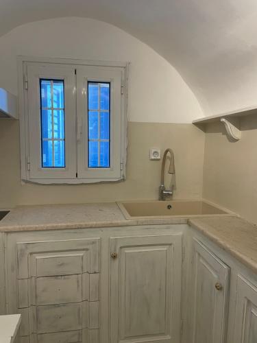 a kitchen with a sink and a window at Silver Lining in Akrotiri