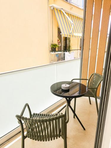 a table and a chair on a balcony at UrbanBay Hotel & Spa in Kavála