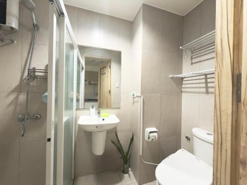 a bathroom with a sink and a toilet and a shower at Inspiria Condominium in Davao City