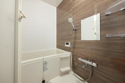 a bathroom with a shower and a sink at nedoko in Sumoto