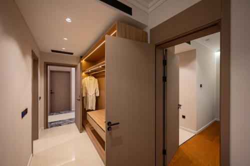 a walk in closet with a door leading to a bedroom at Hotel By Holiday in Rinas