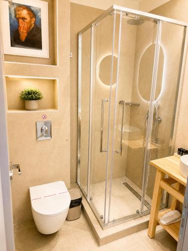 a bathroom with a shower stall and a toilet at UrbanBay Hotel & Spa in Kavála