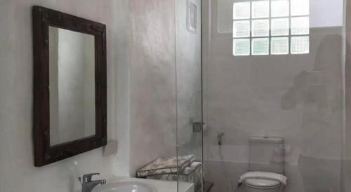 a bathroom with a toilet and a sink and a mirror at Samunthitar Resort in Khao Kho