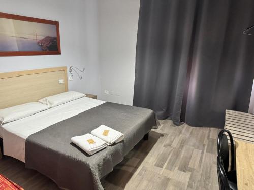 Llit o llits en una habitació de Hotel Galla