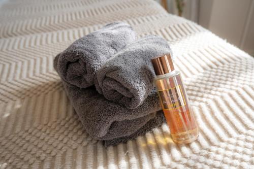 a towel and a bottle of soap on a bed at Ocean Front! New Built Apartment! SOU Resort YAKA in Kin