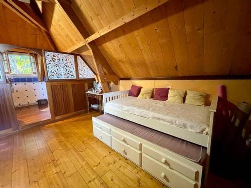 a bedroom with a large bed in a attic at La maison du Ruisseau in Saint-Louis