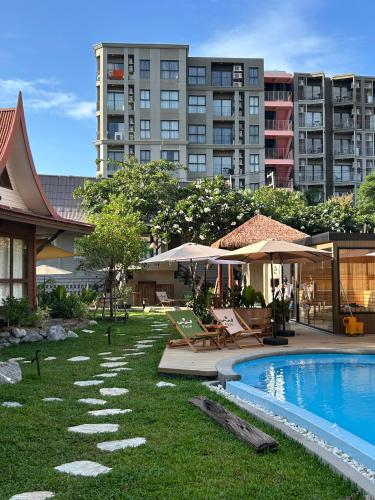 a resort with a swimming pool and a building at Flow Hua Hin - Ice Bath and Villa in Hua Hin