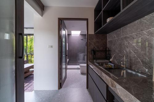 a bathroom with a sink and a toilet in a room at Aranya Bliss Villa 105 in Ban Madua Wan