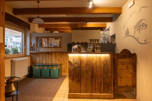 a restaurant with wooden walls and a counter in a room at Mont Velan Chambres & Restaurant in Saint-Oyen