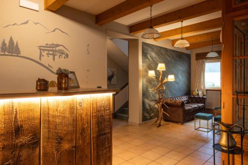 a living room with a wooden bar and a chair at Mont Velan Chambres & Restaurant in Saint-Oyen