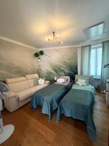 a living room with a couch and two tables at Casa Cri in Mondovì