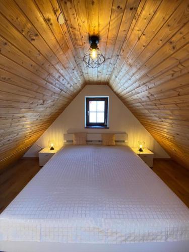 a large white bed in a room with a window at Apartment with a view in Upflamör in Zwiefalten