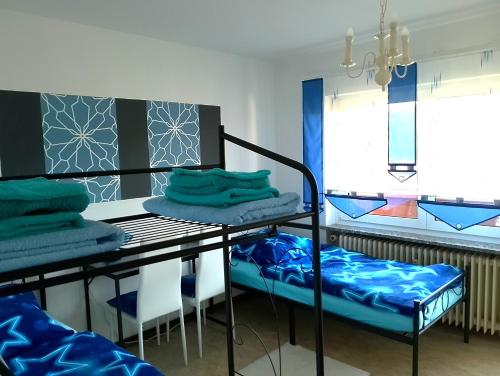 a room with a table and chairs and a table with towels at Ferienwohnung Jahnke in Burkardroth
