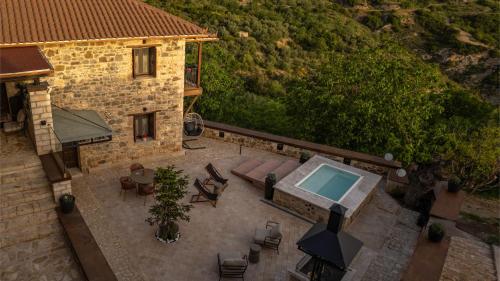 an aerial view of a house with a swimming pool at La Villa de Madeleine - Stone Villa with outdoor hot tub in Arcadia, Peloponnese in Áyios Ioánnis