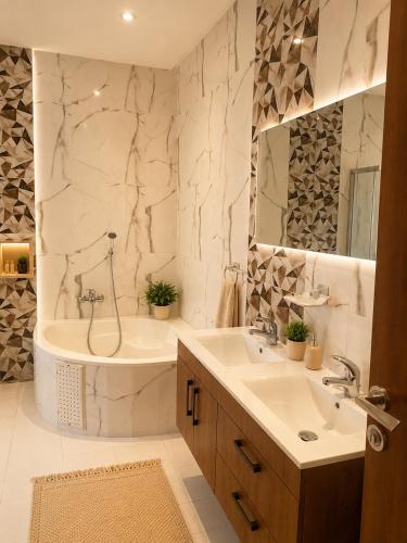a bathroom with a tub and a sink and a shower at Chez Roberto in La Marsa