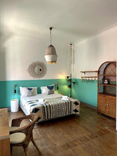 a bedroom with a bed and a blue wall at WOT Lodge Soul in Ericeira