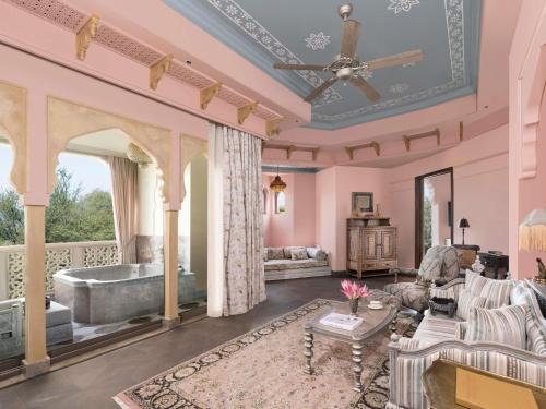 a living room with a tub and a couch at Raffles Jaipur in Jaipur
