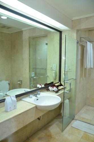 a bathroom with a sink and a shower at Hotel Sahid Jaya Solo in Solo