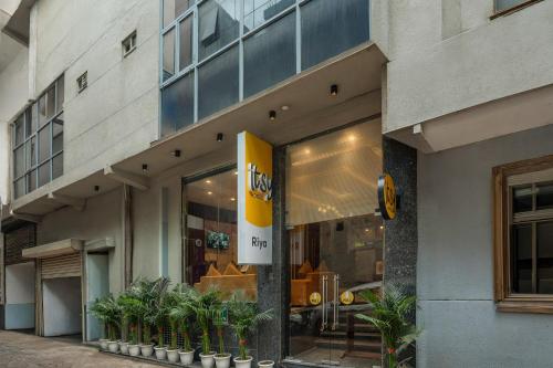 a store front of a building with potted plants at Itsy Hotels Riya Near IGI Airport in New Delhi