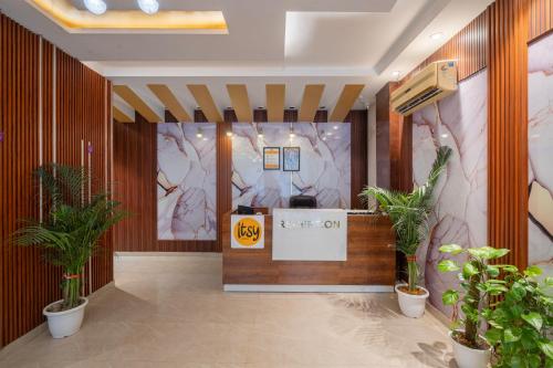 a lobby with a reception desk and potted plants at Itsy Hotels Riya Near IGI Airport in New Delhi