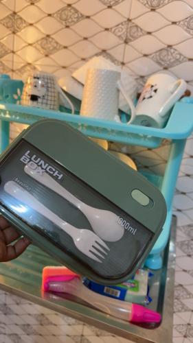 a person holding a cell phone on a shelf at The Cozy Nest in Tanga