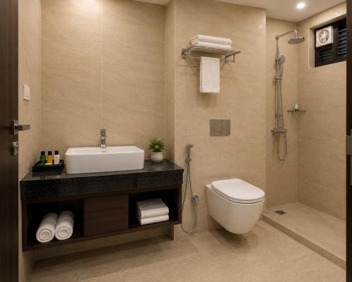 a bathroom with a sink and a toilet and a shower at Hotel Mero Vrindavan in Chhatikara