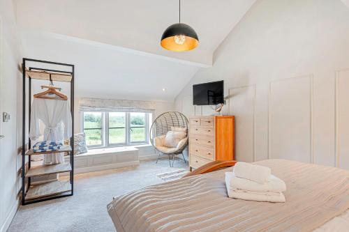 a bedroom with a bed and a dresser and a window at Fairvale House in Northwich