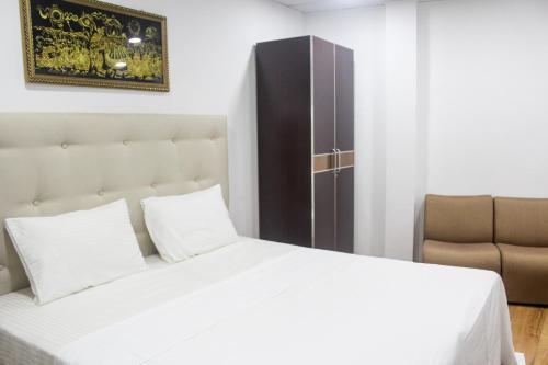 Postel nebo postele na pokoji v ubytování Metro City Hotel
