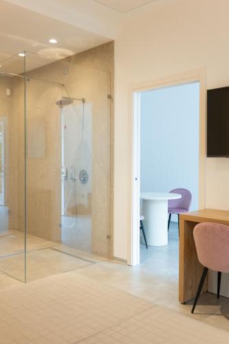 a bathroom with a shower with a glass door at Masseria Stella in Gioia del Colle