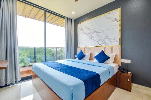 a bedroom with a large bed with a map on the wall at fabhotel nirmal in Lucknow