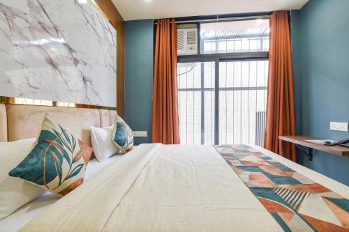 a bedroom with a large bed with a window at fabhotel nirmal in Lucknow
