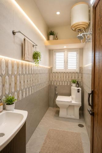 a bathroom with a toilet and a sink at Hotel Ferro in Kumbalgod