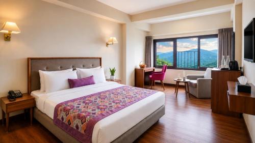 a hotel room with a bed and a living room at Mount Himalayan Hotel in Gangtok
