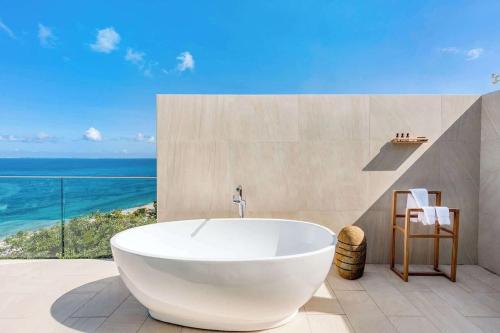 a bath tub in a bathroom with a view of the ocean at Villa with exclusive views in Marigot