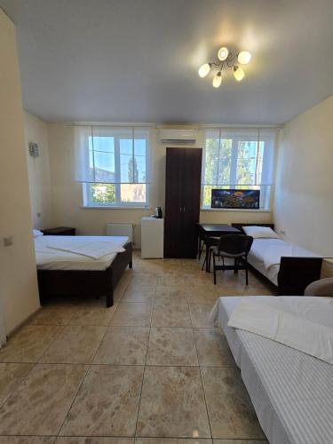 a large room with two beds and a table at ОлександріЯ in Odesa