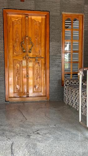 a wooden door on the side of a building at Kds Homestay in Gonikoppal