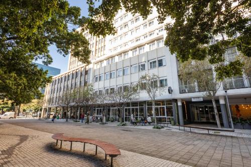 a bench sitting in front of a building at ONOMO Hotel Foreshore in Cape Town