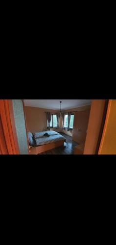 two pictures of a bedroom with a bed in it at Къща за гости Жеглица in Zheglitsa