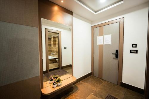 a bathroom with a sink and a mirror at Anaya Regency in Naya Bāzār