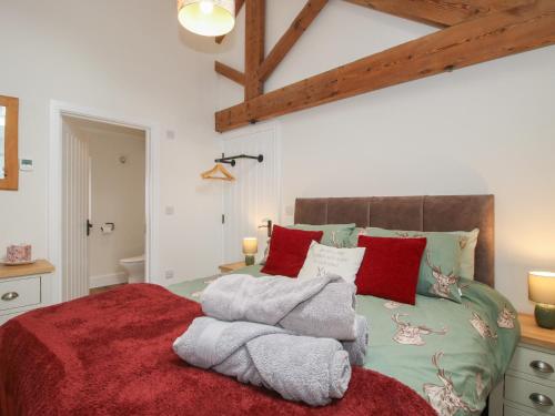 a bedroom with a bed with towels on it at Chestnut Barn in Shrewsbury