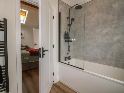 a bathroom with a shower and a glass door at Chestnut Barn in Shrewsbury