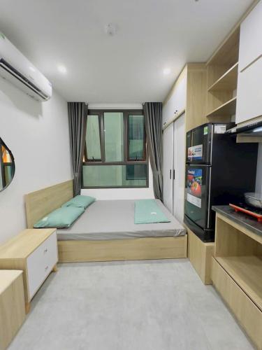a small room with a bed and a tv at Tuệ Tĩnh Hotel in Hải Dương
