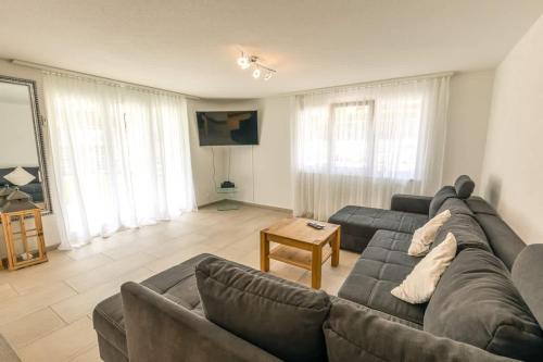 a living room with a couch and a table at Moench Apartment - Aare Jungfrau AG in Wilderswil